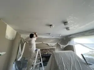 Painter working on ceiling repairs