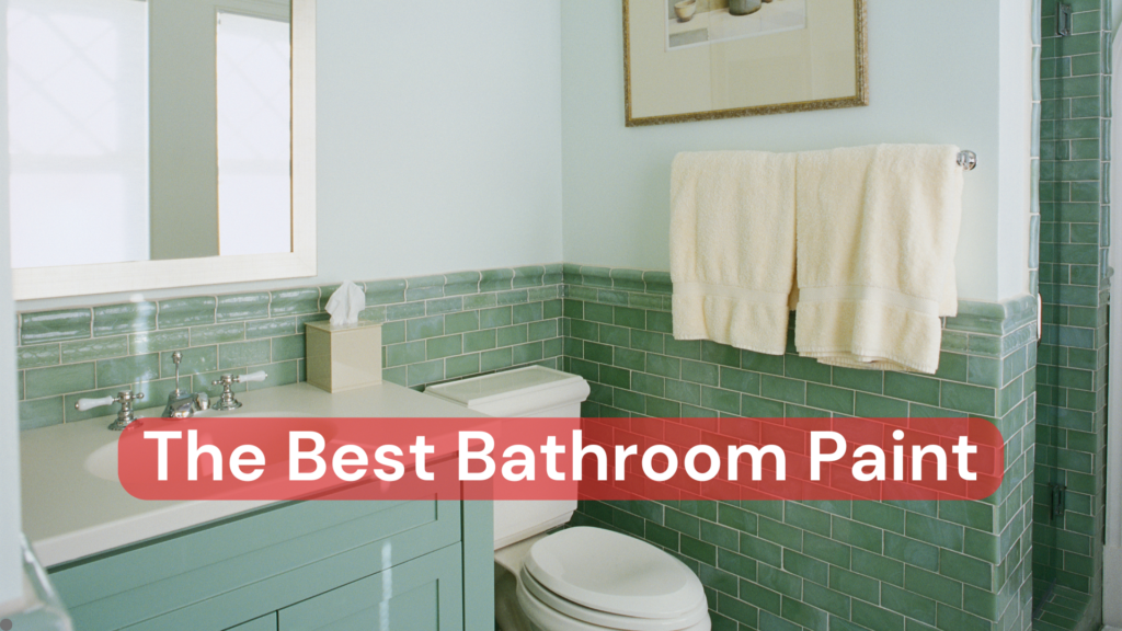 A bathroom with beautiful green tiles, a green vanity and fresh white bathroom paint