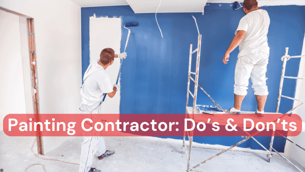 A painting contractor and his assistant paining a blue wall